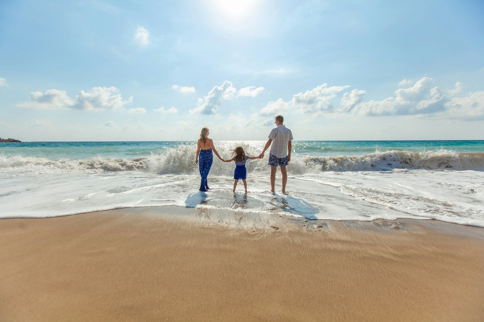 Family holding hands together at the beach